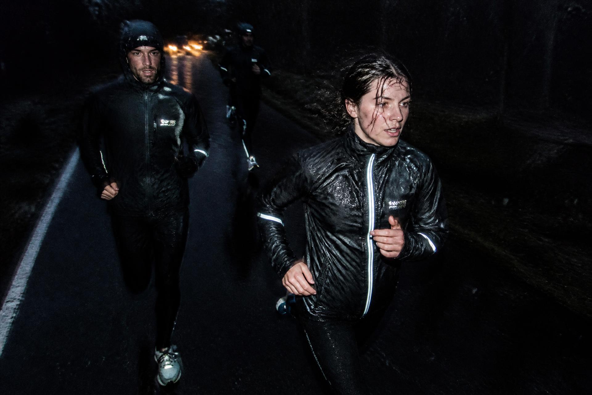 Runners on a wet road at dusk in the rain outside Sundsvall
